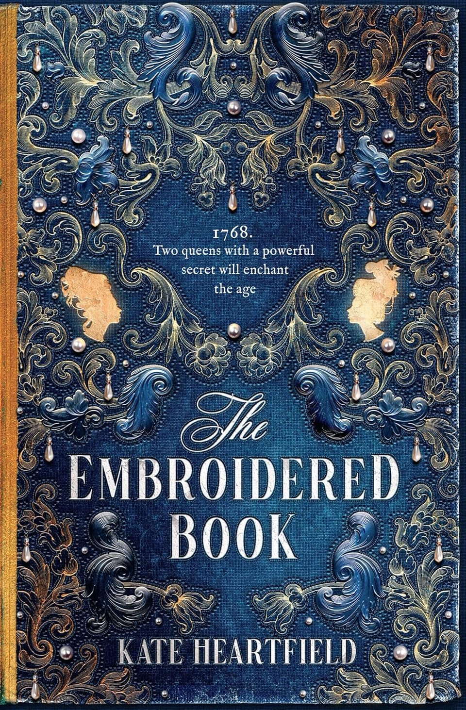 The cover of The Embroidered Book, desgned by Andrew Davis, is blue with baroque elements.