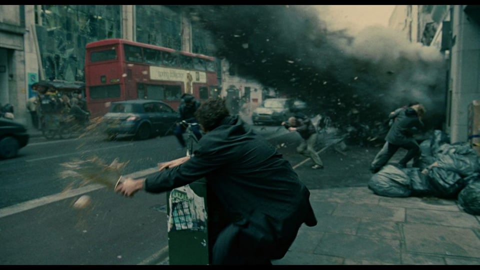 Scene from the movie "Children of Men" where a building blows up and people run.