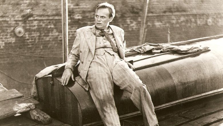 Richard Widmark leaning on (maybe?) a boat, clothes disheveled, looking wild-eyed and plotting.
