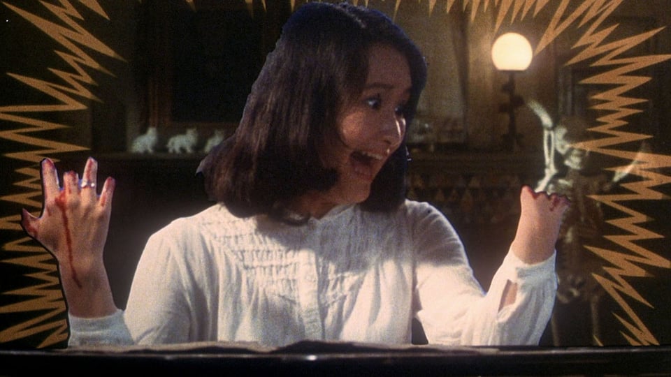A frame from House (1977) where Melody has her hands eaten by the piano.