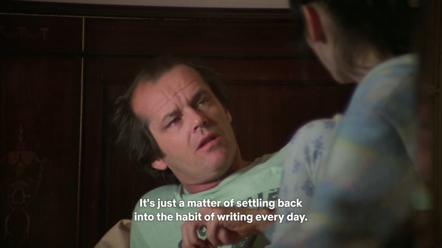 Jack looking at Wendy with a confused look on his face as she tells him that he’ll get past his writer’s block because “It’s just a matter of settling back into the habit of writing every day.”
