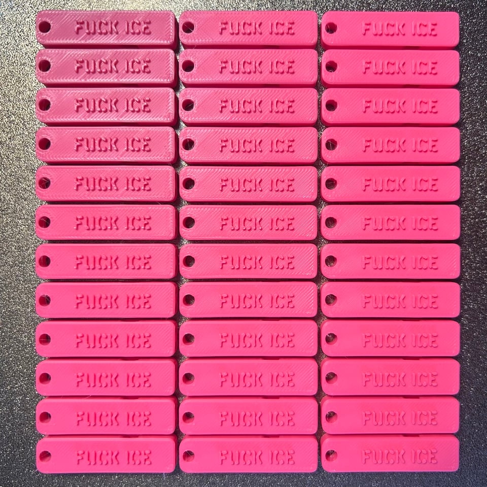 36 hot pink whistles that say FUCK ICE fresh off a 3D printer.