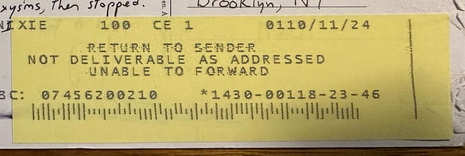 photo of "Return To Sender" label on a postcard