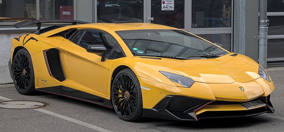 A yellow Lamborghini Aventador (a low slinky-looking sports car, that probably goes very fast)