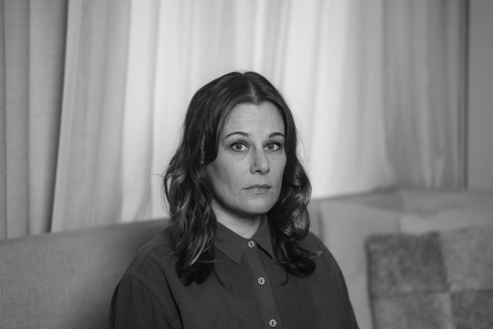 black and white photo of Lexi Kent-Monning sitting on a couch
