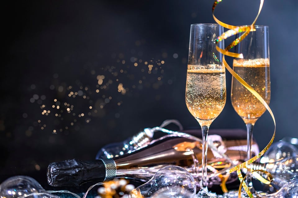 two glasses of champagne on a black background