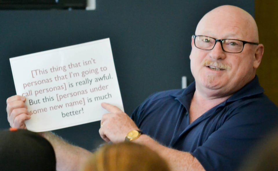Alan Cooper holding up a sign reading [This thing that isn't persona that I'm going to call personas] is really awful. But this [personas under some new name] is much better!