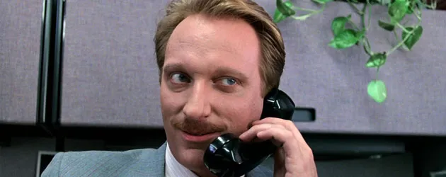 Jeffrey Jones as Dean of Students Ed Rooney, chatting on the telephone in Ferris Bueller's Day Off.