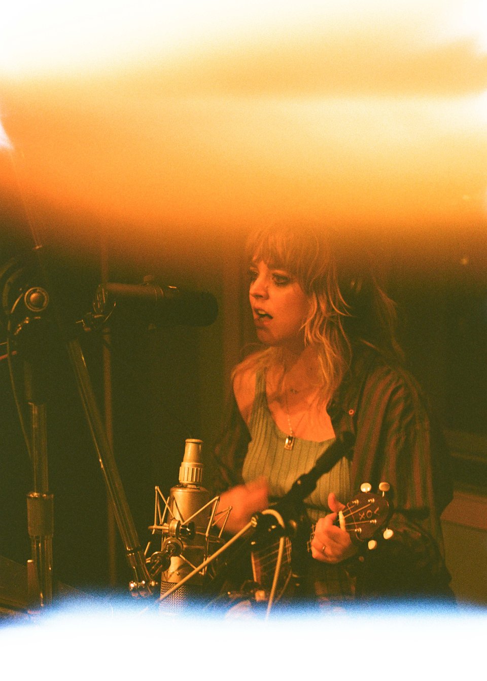sydney playing the electric ukele in a recording studio