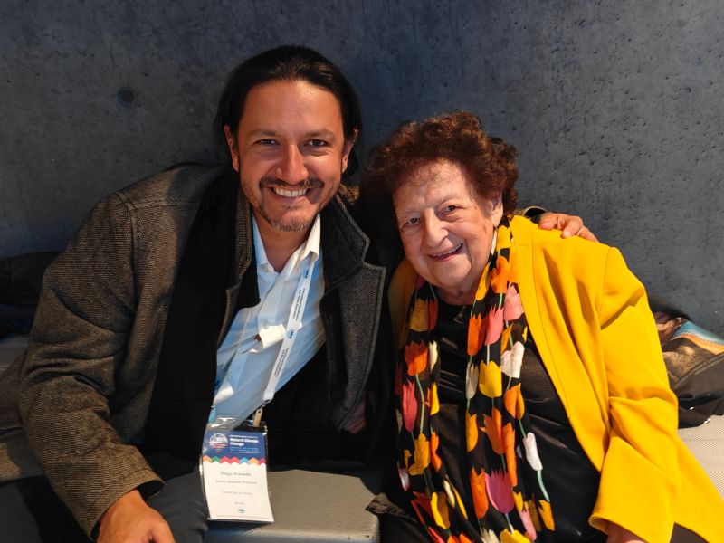 Picture of Diego with a woman at the conference, both smiling broadly into the camera. Diego has his conference badge showing.