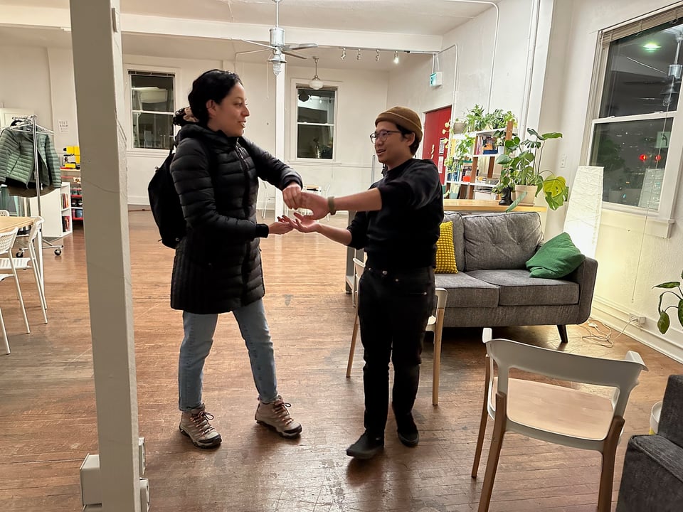 Rebeca teaching Norton how to salsa.