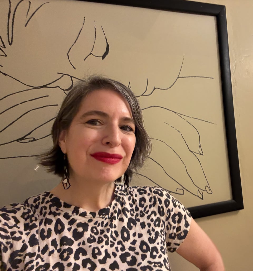 woman in leopard t-shirt and long earrings wearing red lipstick