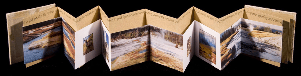 a folded book of photos of Yellowstone park in the late fall, early winter, with a dusting of snow on the ground.