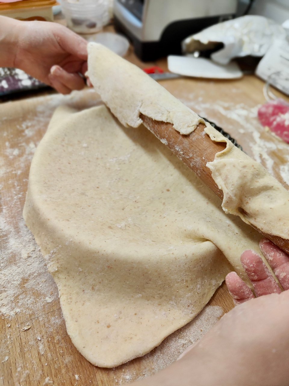 Pastry being rolled into a tin