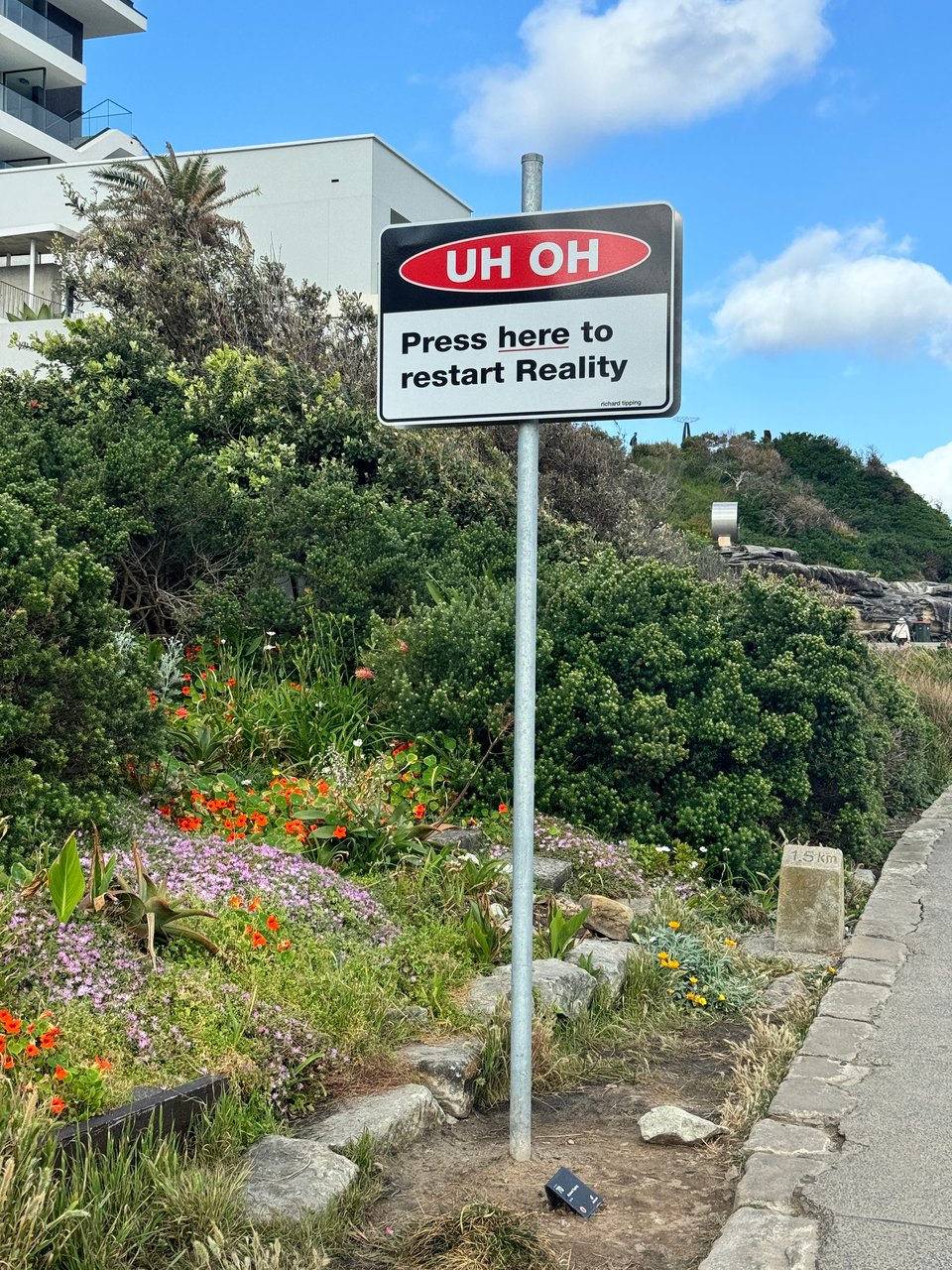An official-looking sign that says "Uh oh, press here to restart Reality"