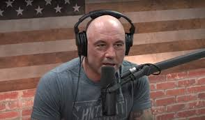 A picture of Joe Rogan hosting his podcast. Rogan frequently platforms far right figures and vaccine deniers.