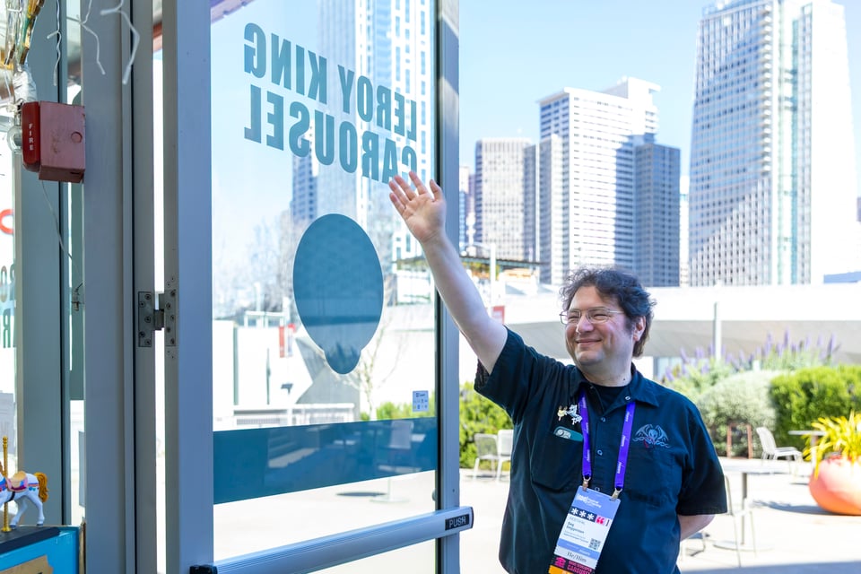 Seg waving to unseen riders of the LeRoy King Carousel.