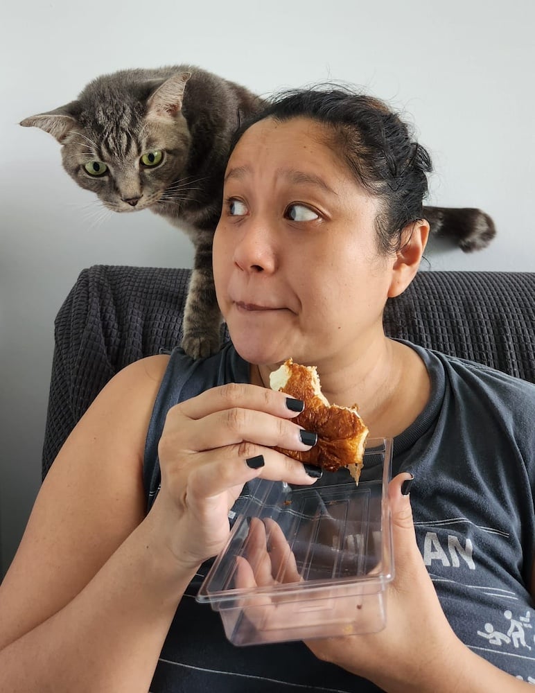 A photo of Luca eyeing Nadia's salmon croissant.