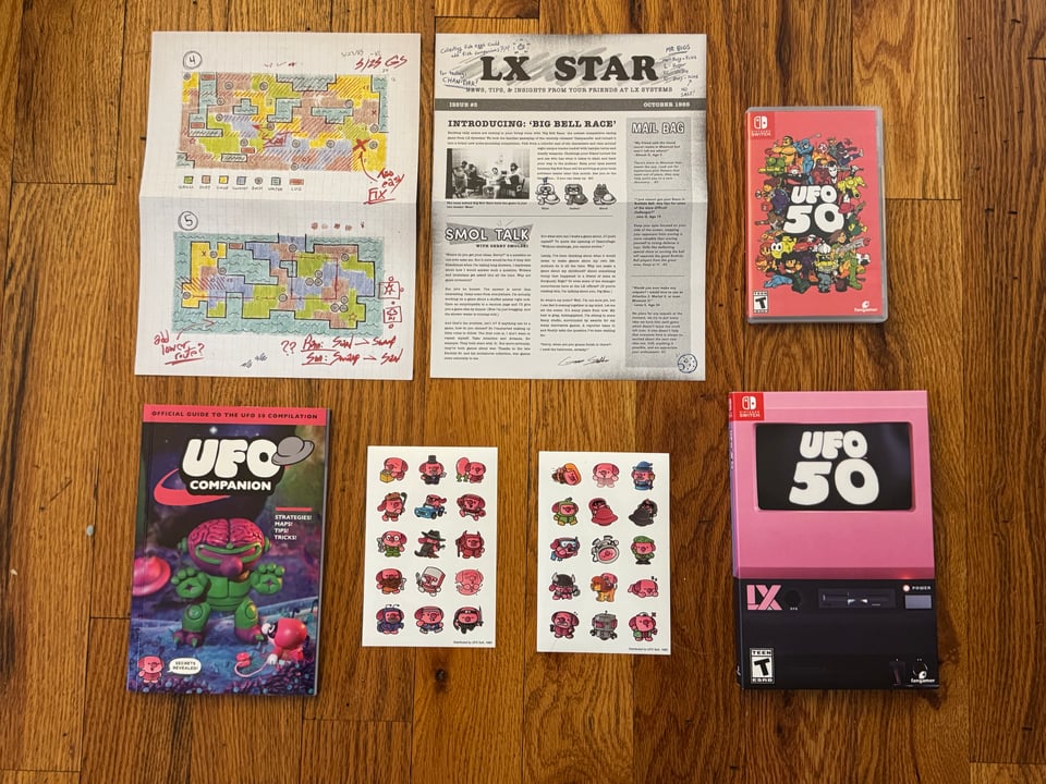 The UFO 50 Deluxe Edition, featuring stickers, a UFO Companion Guide, a special edition box, the physical game, a fictional 'LX Star' newsletter and maps of the game Camouflage.