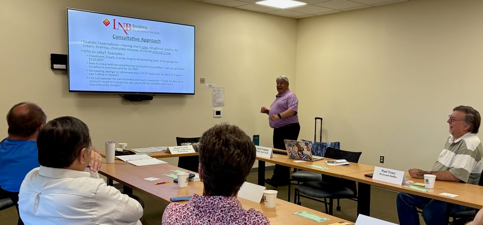 Kevin presents to the NRG members with accompanying presentation on the wall screen.