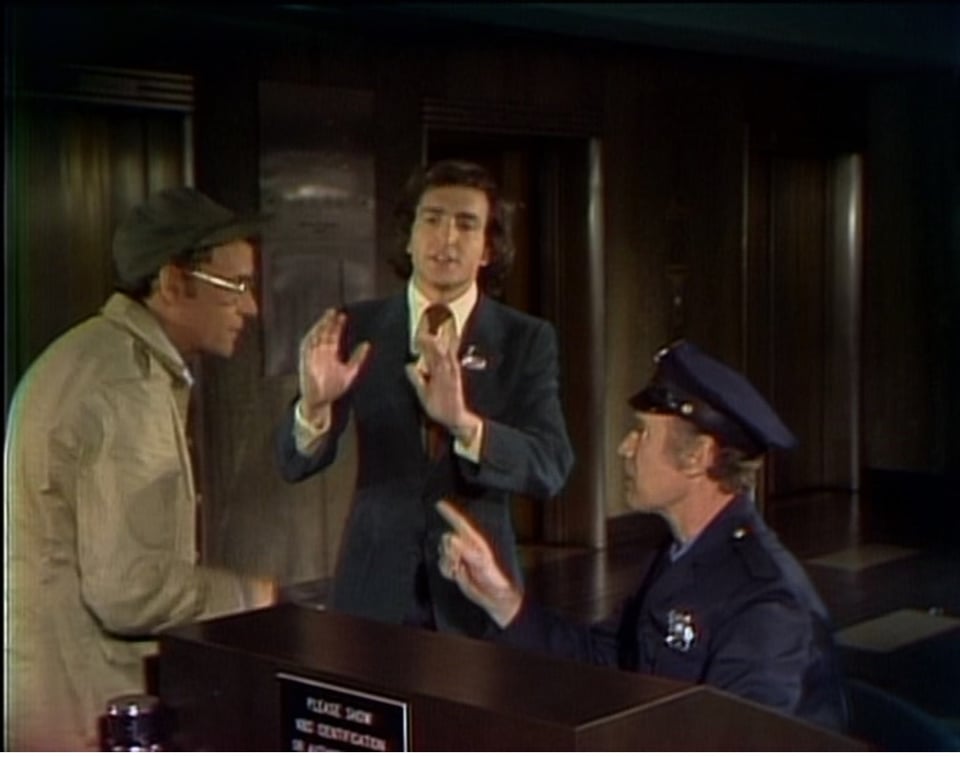 three men in uniform talking to each other