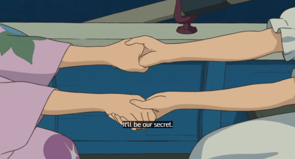Another closeup of Anna and Marnie holding hands. Marnie is saying,
