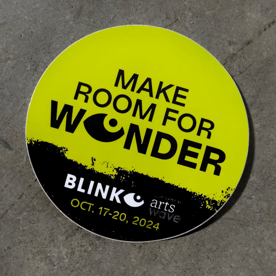 Chartreuse and black round sticker that says make room for wonder blink October 17-20 2024.