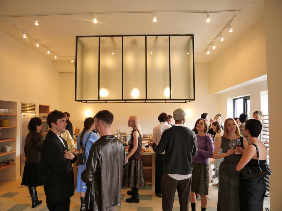 People gather around the open kitchen area.