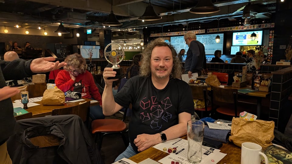 Andrew lifting aloft the car wars trophy in a packed Brewdog pub.