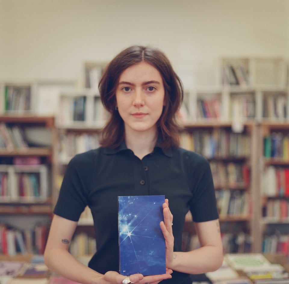 [Chaski holding up a copy of the Are.na Annual, vol. 7 “pool” (!)]