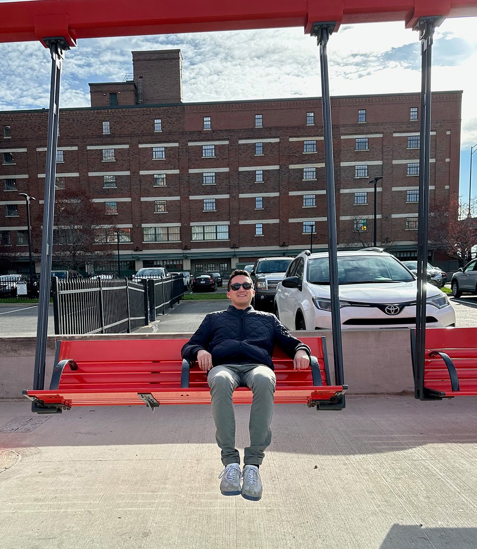 The author sitting on a swing.