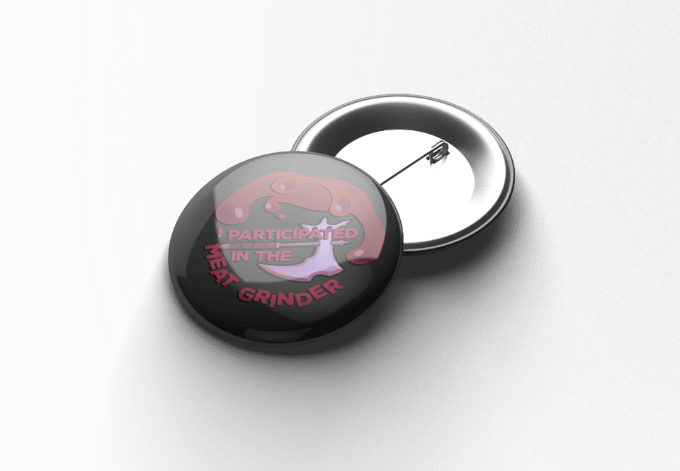 Mockup of pin showing "I participated in the Meat Grinder" with an axe and blood.