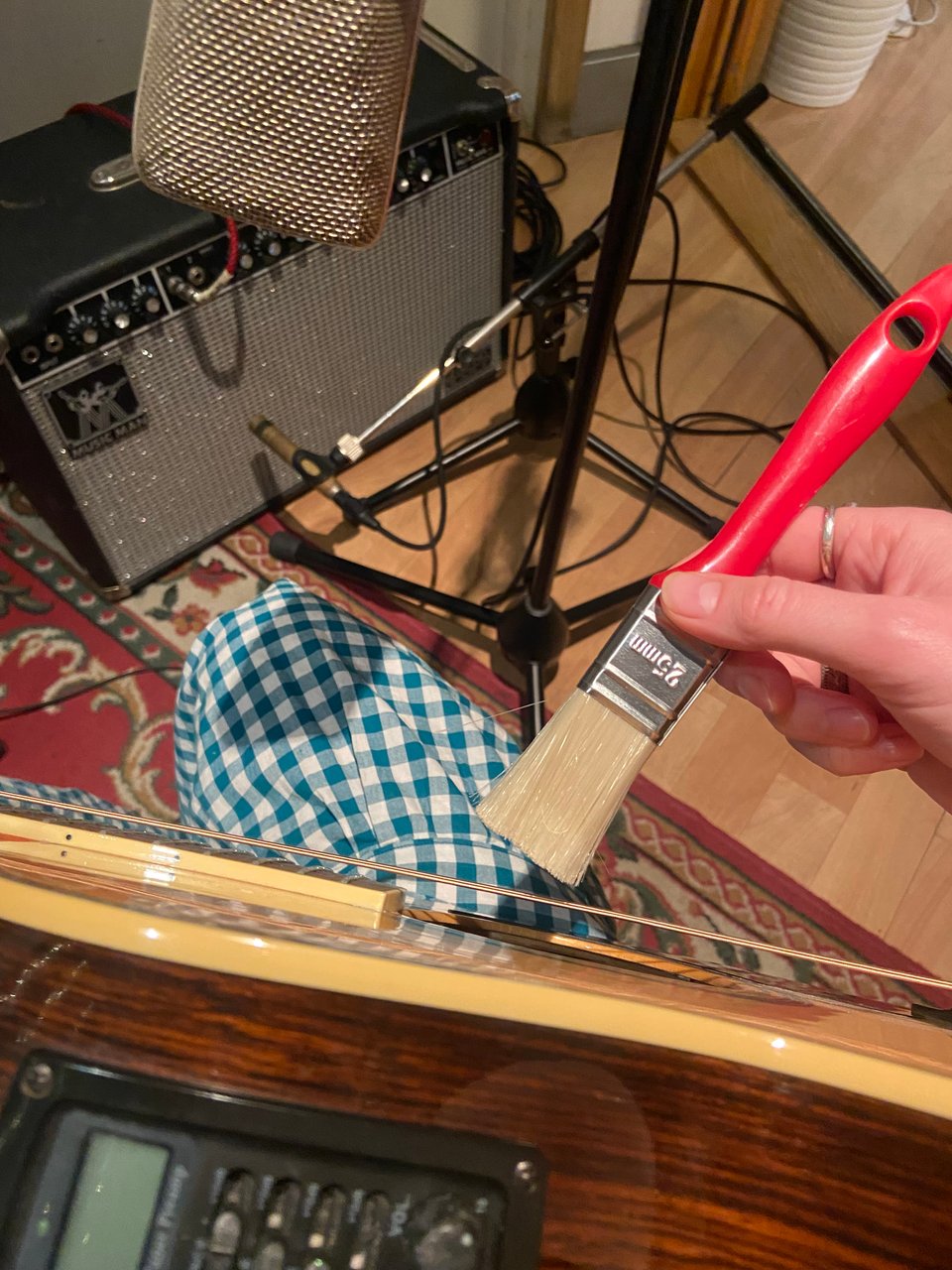 a person using a brush to play a guitar