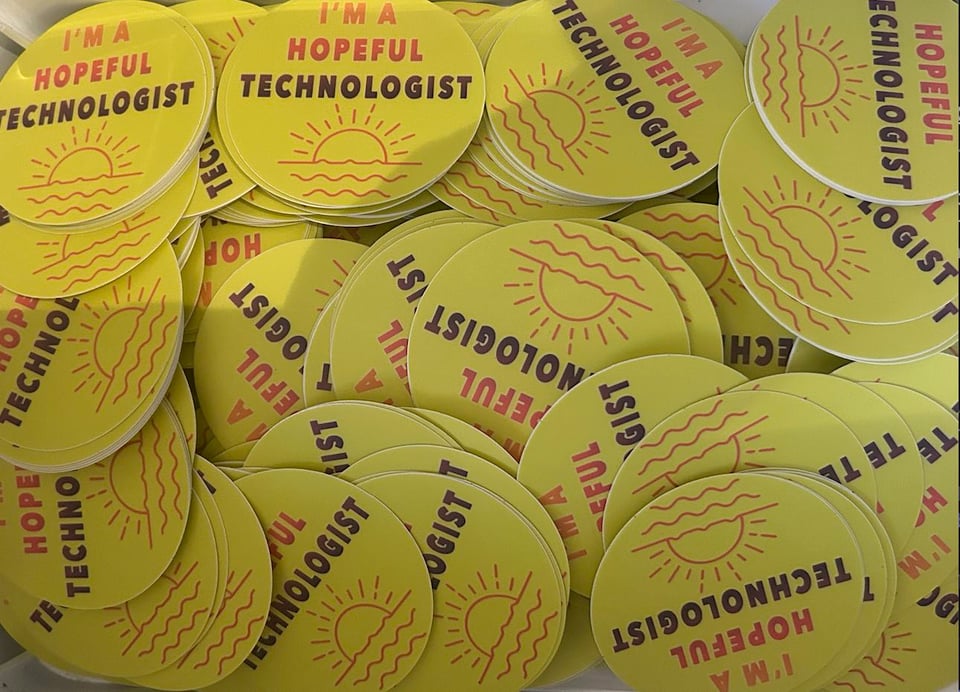 A box of stickers that say “I’m a hopeful technologist”