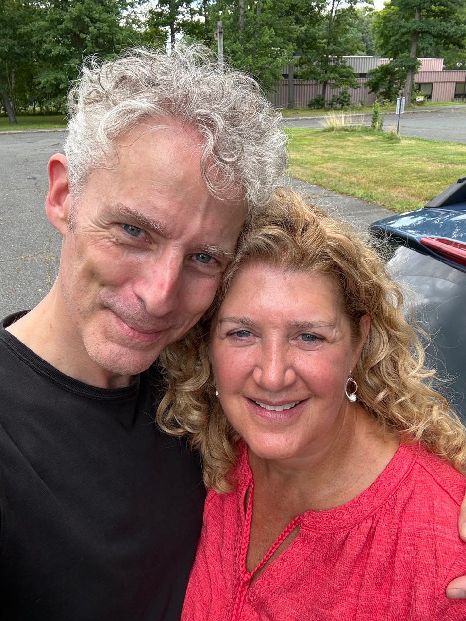 selfie of white man and woman in their mid-50s, looking happy