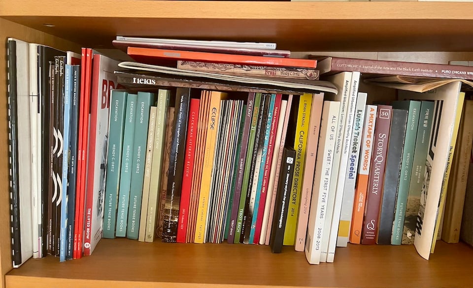 a bookshelf full of books and literary journals