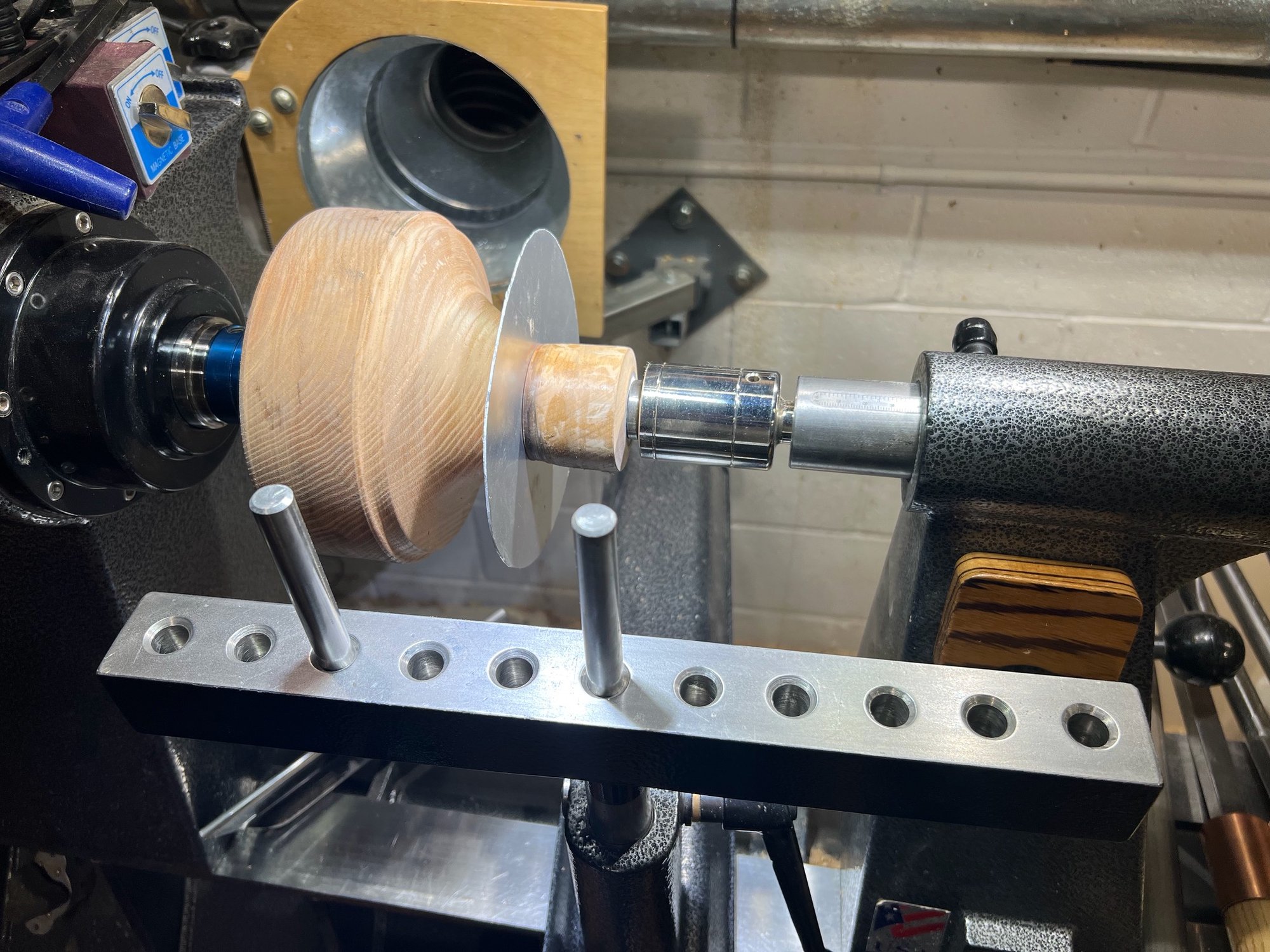 The lathe setup for spinning the bowl