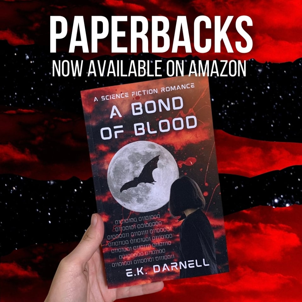 An image of a hand holding a paperback copy of A Bond of Blood