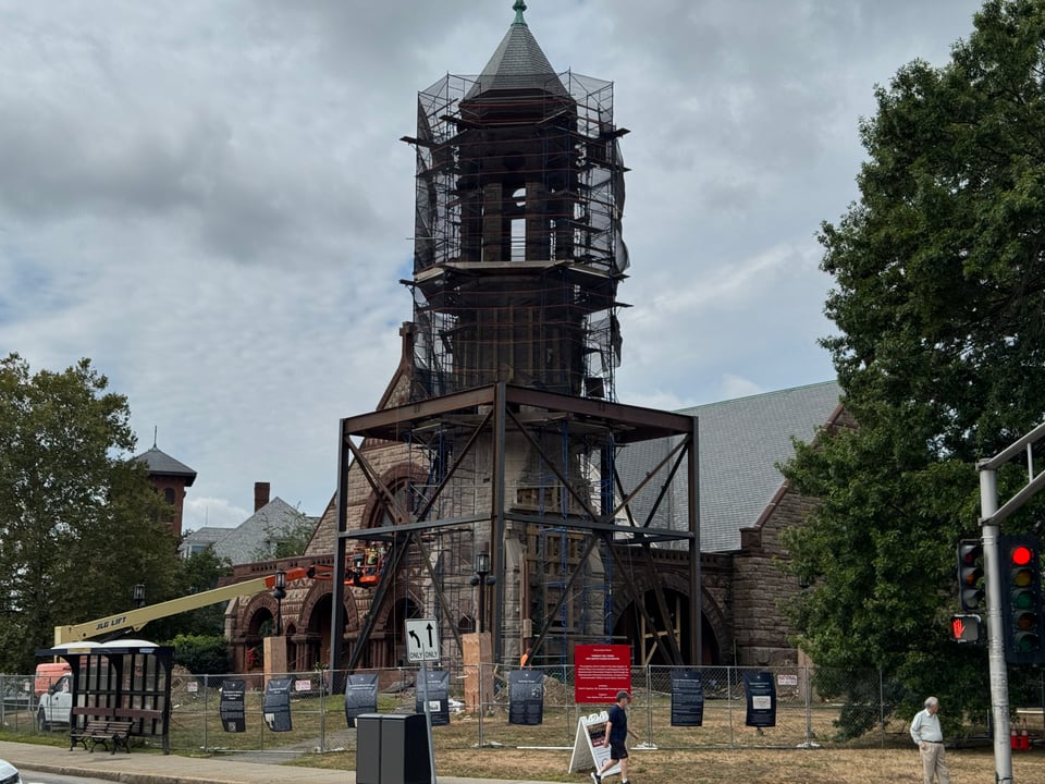 A contemporary photograph of the church tower with metal and wood supports around it