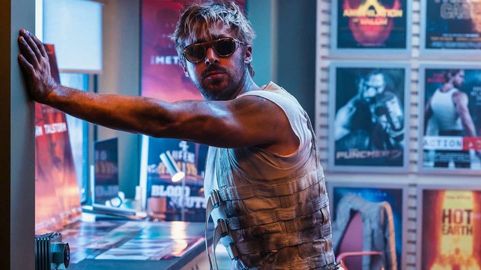 A shot from The Fall Guy. Ryan Gosling with sunglasses among movie posters.