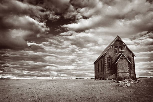 a church in the midst of the plains of the mid west, moody black and white photo