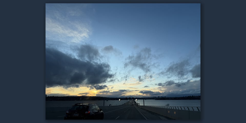 A darkening blue sky with wisps of orangey yellow sunset