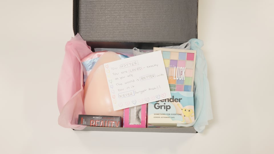 Image of a kit including a note, breast forms, makeup, gaff