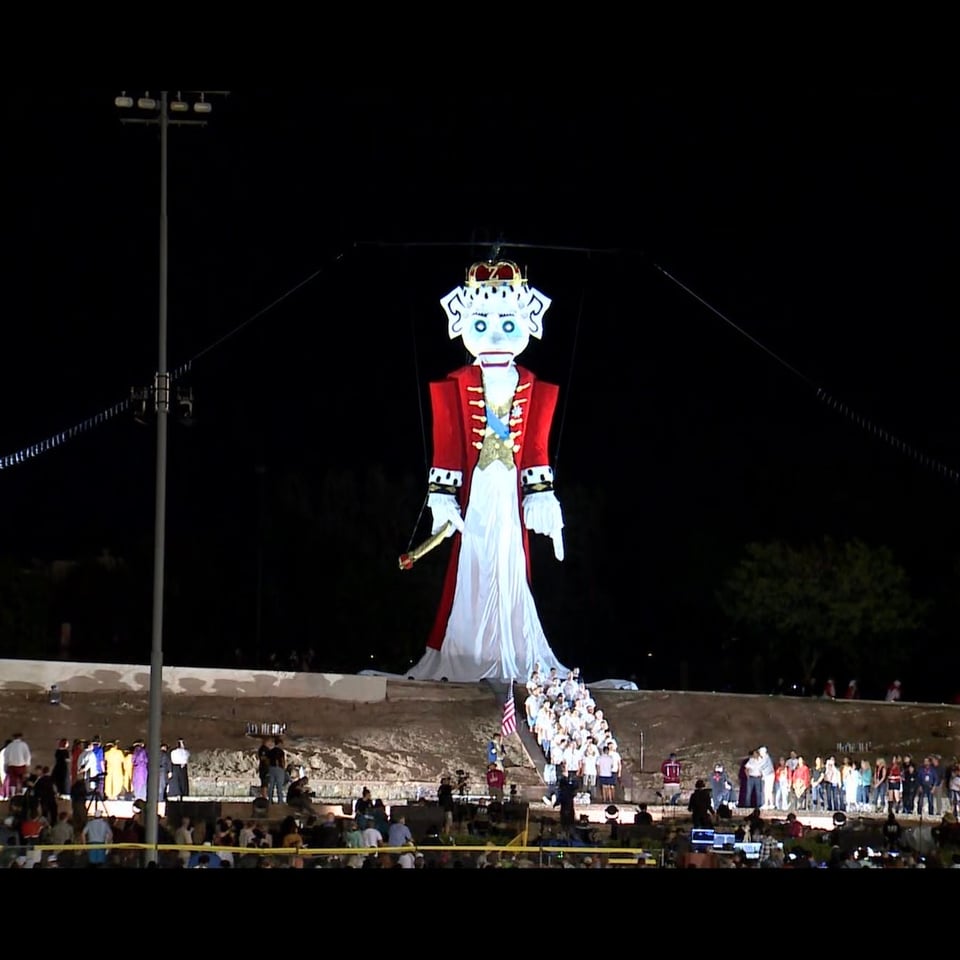 50' puppet named Zozobra, dressed as King George III, overlooking the audience before the Fire Spirit arrives.