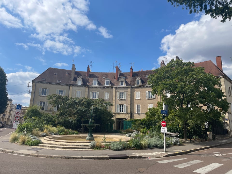 Beautiful corner mansion that is set back from the intersection and concave to give more space. There is a garden with a circular fountain in front.  Beautiful corner mansion that is set back from the intersection and concave to give more space. There is a garden with a circular fountain in front.