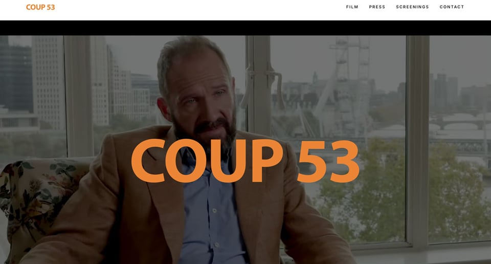 A screenshot from the website coup53.com which shows a seated Ralph Fiennes representing the MI6 agent Norman Darbyshire.