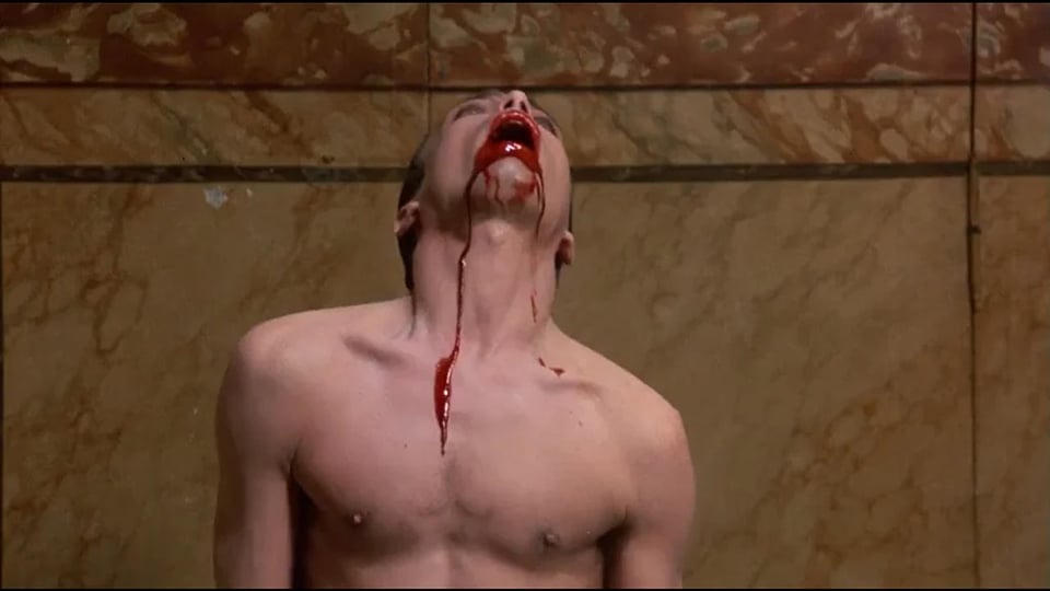 Udo Kier, shirtless and hot as Dracula, head raised up in agony as not-exactly-virginal blood pours out of his mouth and down his neck to his chest.