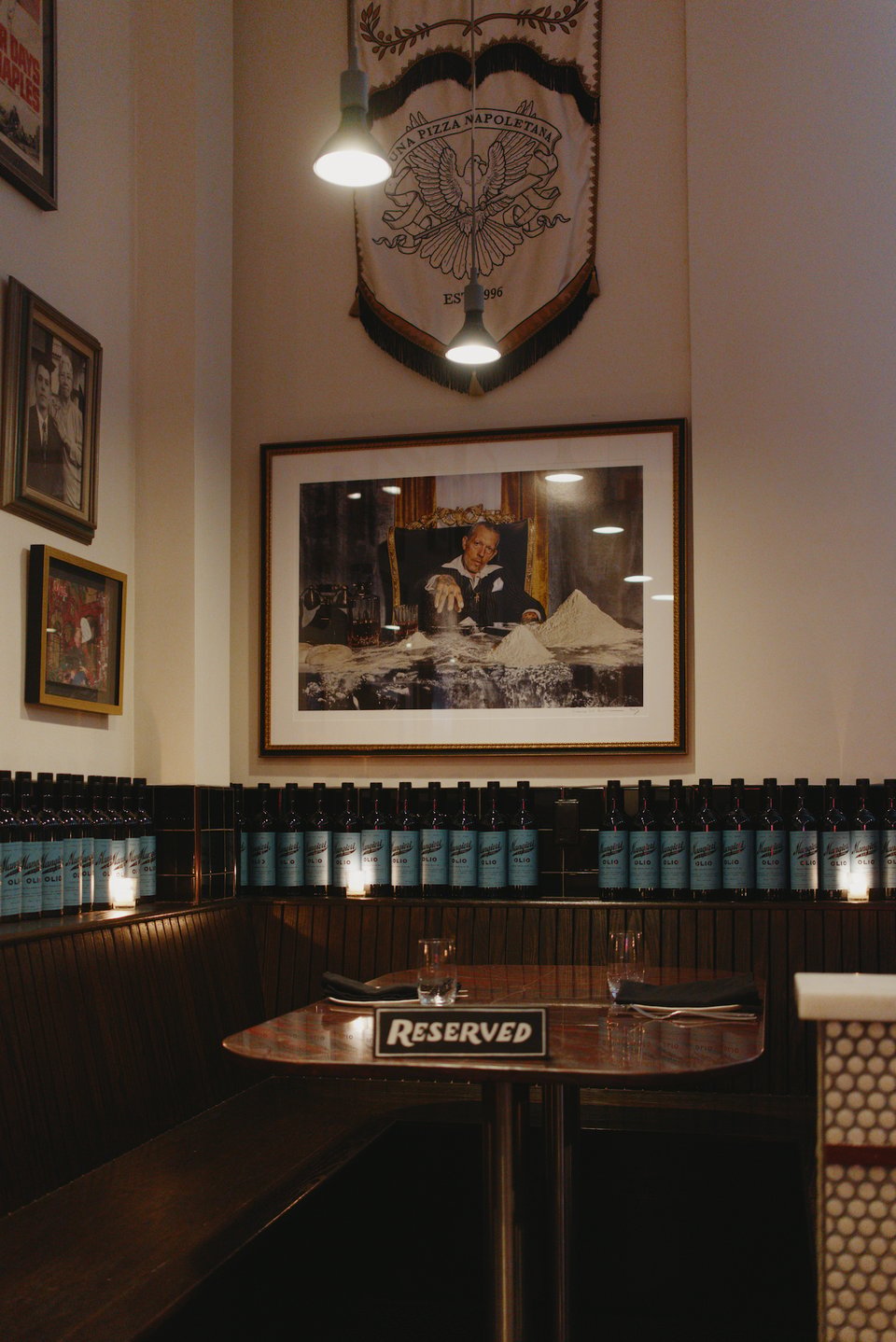 The reserved booth at Una Pizza, with an amusing photo of owner and chef Anthony Mangieri presiding over piles of flour in a Godfather-like parody.