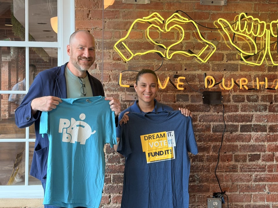 Matthew Slaats (Richmond People’s Budget) and Carmen Ortiz (PB Durham) posing during a ‘t shirt swap’