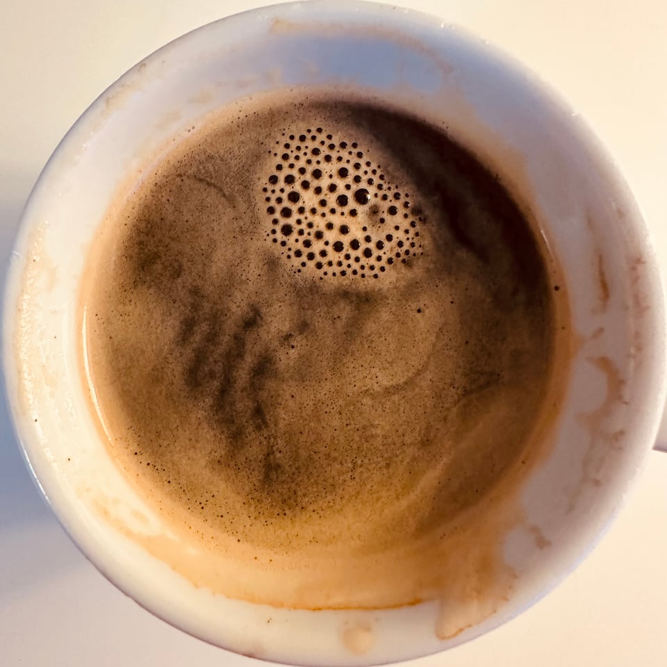 photo from above of a coffee cup holding an Americano